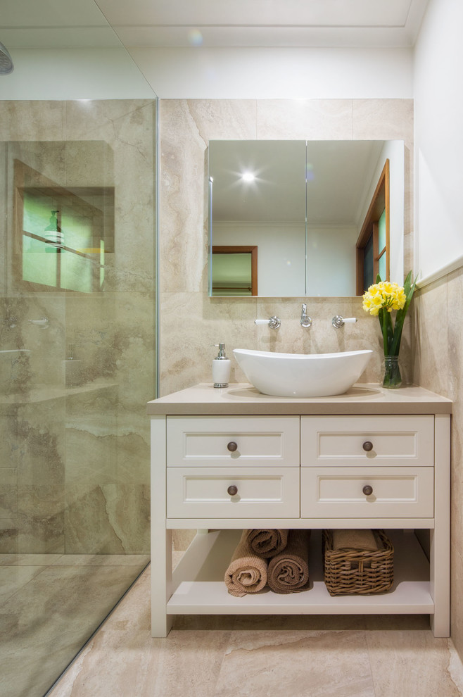Ejemplo de cuarto de baño clásico pequeño con lavabo sobreencimera, puertas de armario blancas, ducha a ras de suelo, baldosas y/o azulejos beige, paredes blancas y suelo de baldosas de porcelana