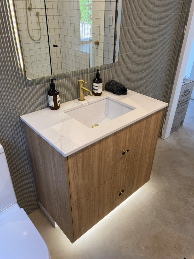 Inspiration pour une salle de bain design avec une baignoire posée, une douche d'angle, un carrelage blanc, sol en béton ciré, un plan de toilette en marbre, un sol gris, une cabine de douche à porte battante et un plan de toilette blanc.