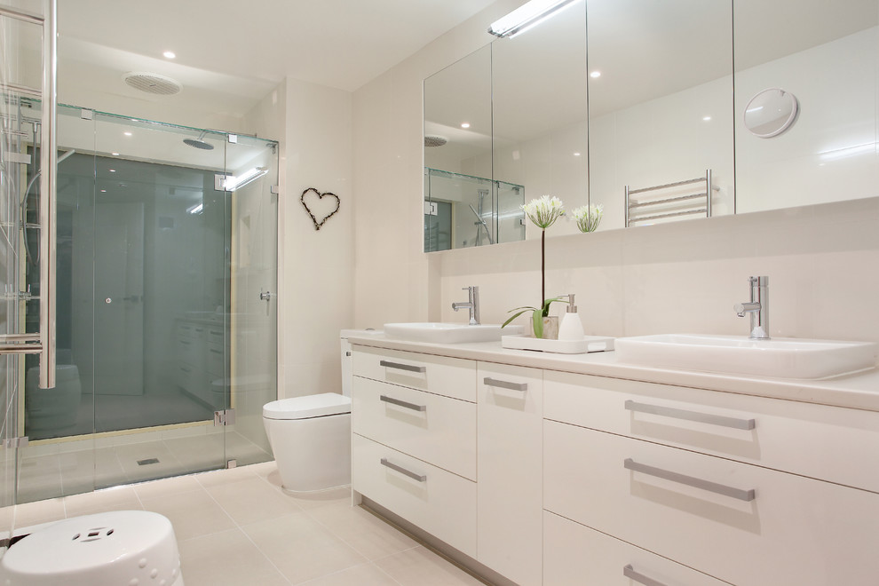 Inspiration for a contemporary alcove shower remodel in Melbourne with flat-panel cabinets, white cabinets and a drop-in sink