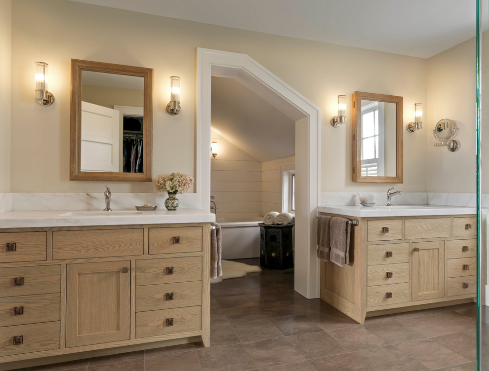 Inspiration for an expansive ensuite wet room bathroom in Burlington with flat-panel cabinets, medium wood cabinets, a freestanding bath, beige walls, ceramic flooring, a submerged sink, marble worktops, brown floors and a hinged door.