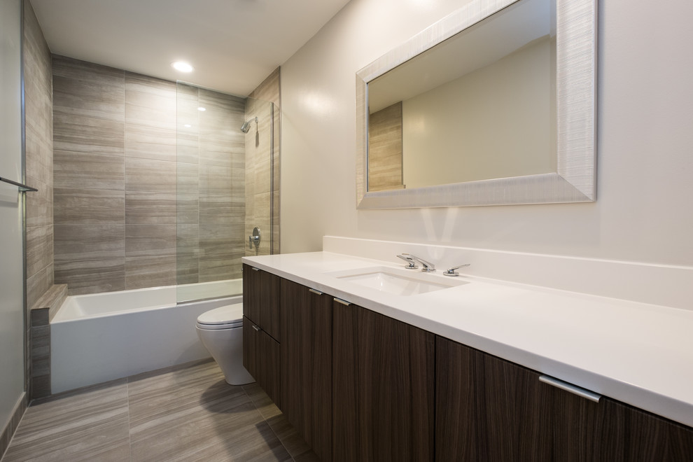 Mid-sized minimalist gray tile and porcelain tile porcelain tile bathroom photo in Portland with flat-panel cabinets, dark wood cabinets, white walls, an undermount sink and quartz countertops