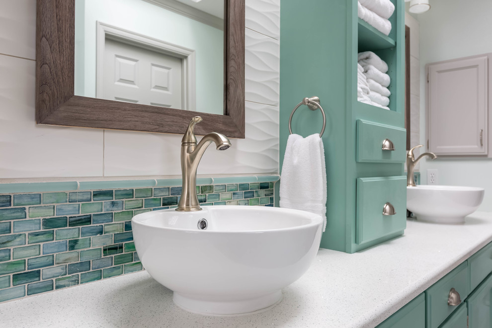 Photo of a large traditional ensuite half tiled bathroom in Seattle with turquoise cabinets, a freestanding bath, white tiles, glass tiles, porcelain flooring, a vessel sink, engineered stone worktops, grey floors, a hinged door, a corner shower, recessed-panel cabinets and white walls.
