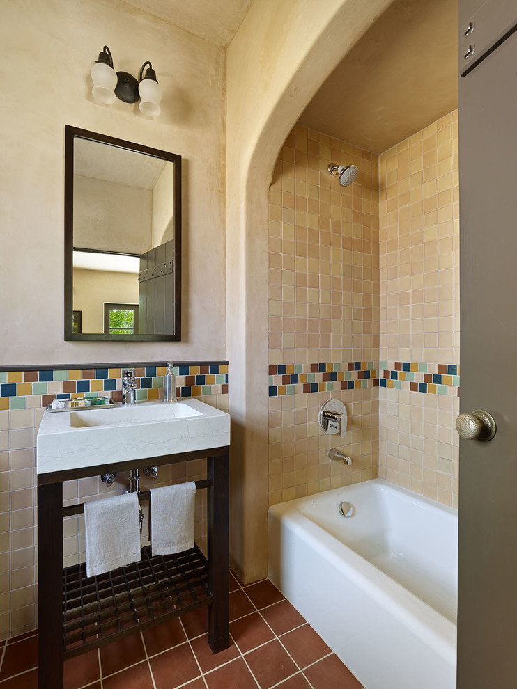 Inspiration for a mediterranean bathroom in San Francisco with a console sink, an alcove bath, a shower/bath combination, multi-coloured tiles, ceramic tiles and beige walls.