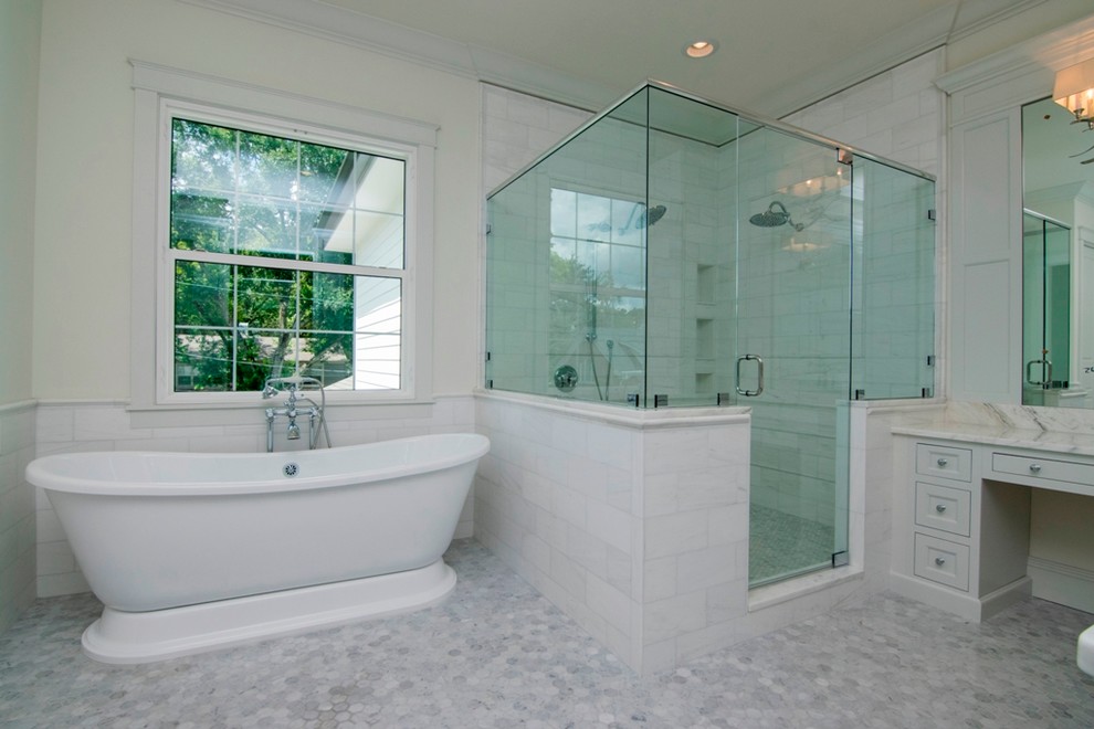 This is an example of a large classic ensuite bathroom in Tampa with shaker cabinets, white cabinets, a freestanding bath, an alcove shower, white tiles, white walls, marble flooring, granite worktops, grey floors and a hinged door.