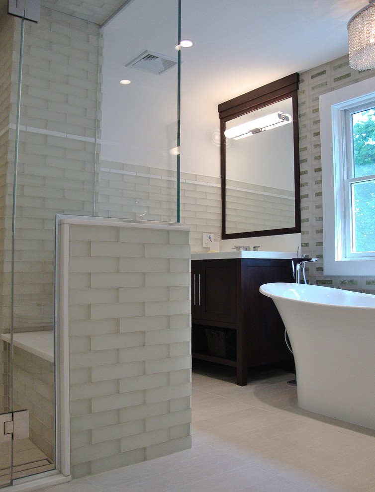 Example of a transitional beige tile and glass tile bathroom design in New York with an undermount sink, furniture-like cabinets, dark wood cabinets and a one-piece toilet