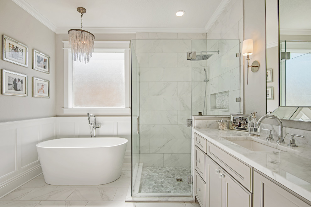 This is an example of a large classic ensuite bathroom in Tampa with flat-panel cabinets, beige cabinets, a hot tub, a corner shower, a one-piece toilet, grey tiles, marble tiles, beige walls, marble flooring, a submerged sink, engineered stone worktops, white floors, a sliding door, white worktops, a wall niche, double sinks and a built in vanity unit.