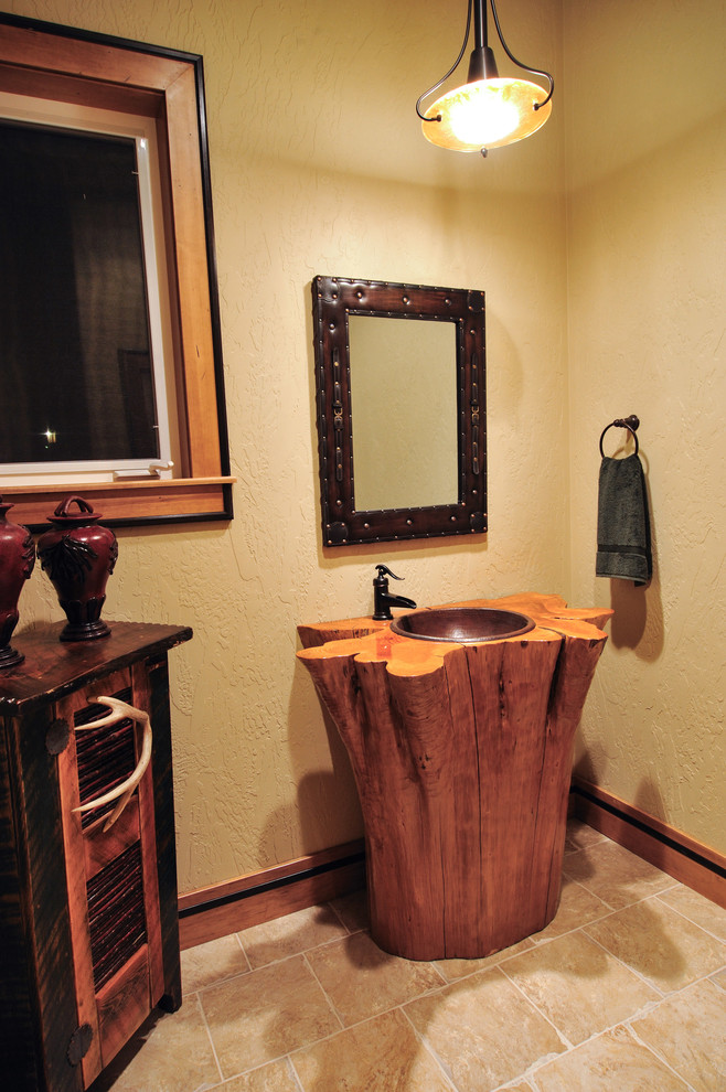 シアトルにあるラグジュアリーな小さなラスティックスタイルのおしゃれなトイレ・洗面所 (ペデスタルシンク、オープンシェルフ、中間色木目調キャビネット、分離型トイレ、ベージュのタイル、セラミックタイル、ベージュの壁、トラバーチンの床、木製洗面台) の写真
