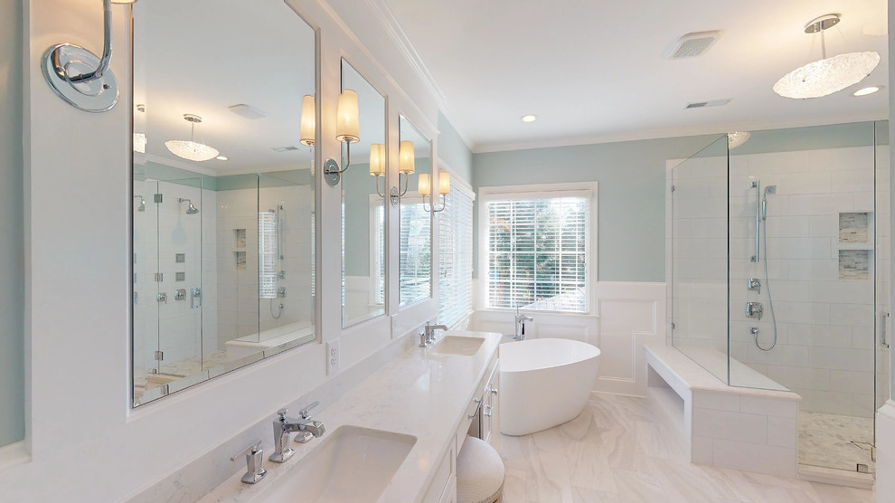 Design ideas for a large traditional ensuite bathroom in Raleigh with shaker cabinets, white cabinets, a freestanding bath, a corner shower, a two-piece toilet, white tiles, porcelain tiles, blue walls, porcelain flooring, a submerged sink, engineered stone worktops, grey floors, a hinged door and white worktops.