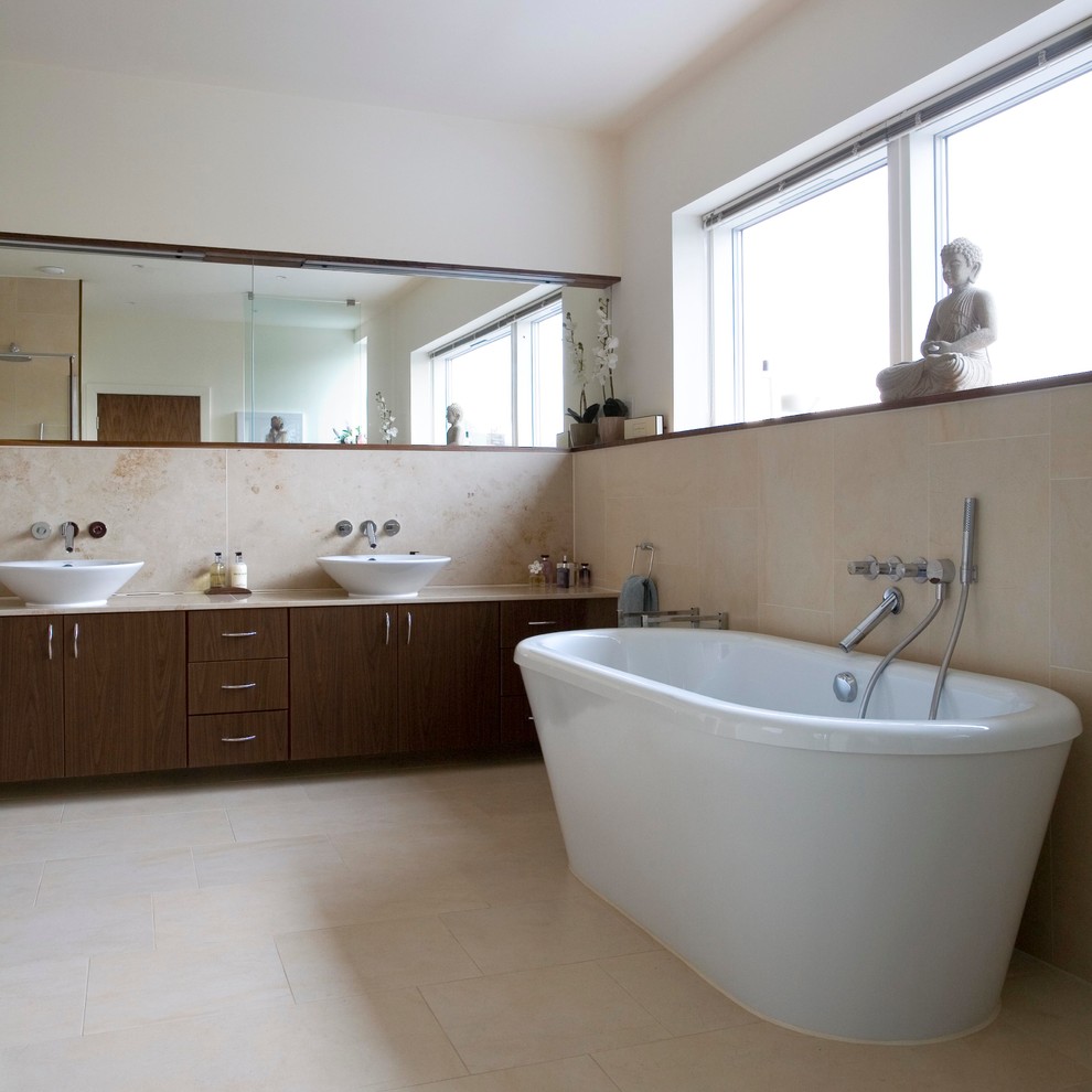 Freestanding bathtub - mid-sized contemporary master white tile and porcelain tile porcelain tile freestanding bathtub idea in Edinburgh with furniture-like cabinets, dark wood cabinets, limestone countertops and white walls