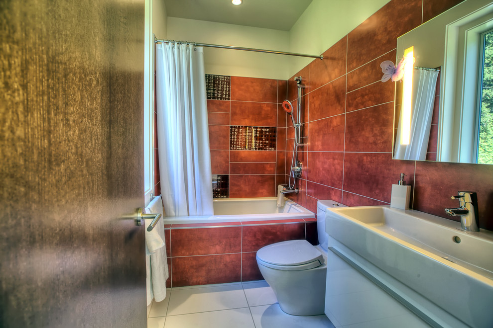 Bathroom - mid-sized modern kids' red tile and porcelain tile porcelain tile bathroom idea in Seattle with a vessel sink, flat-panel cabinets, white cabinets, solid surface countertops, a two-piece toilet and white walls