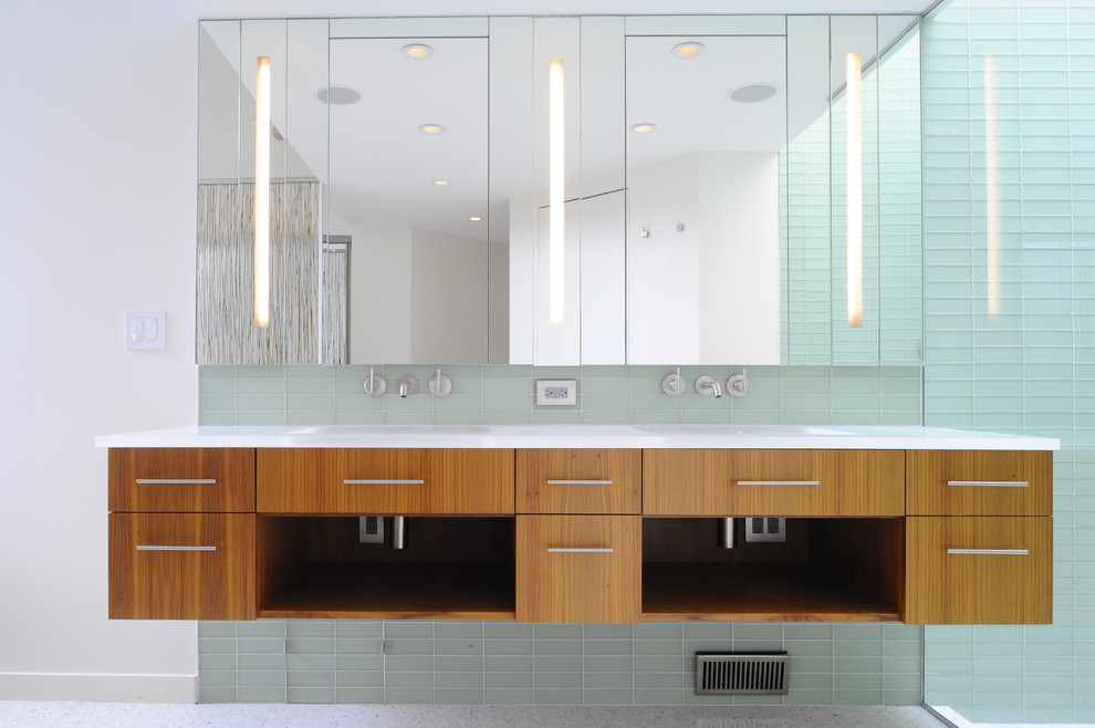 Medium sized contemporary ensuite bathroom in San Francisco with an integrated sink, flat-panel cabinets, medium wood cabinets, an alcove bath, a built-in shower, a one-piece toilet, green tiles, glass tiles, green walls and porcelain flooring.