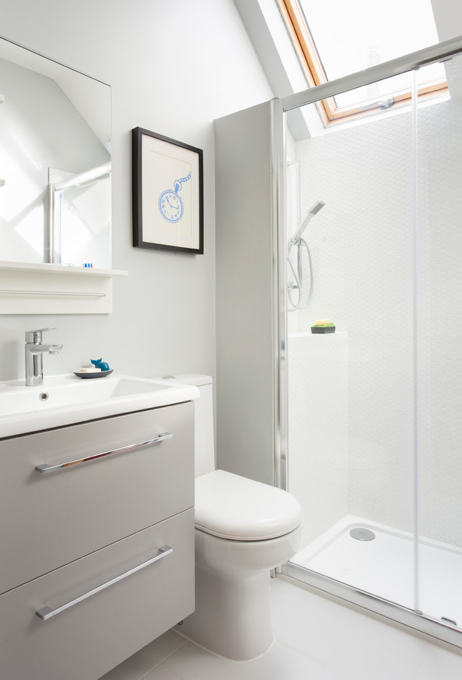 Traditional bathroom in London with flat-panel cabinets, white cabinets, an alcove shower, white tiles, white walls, a console sink and a sliding door.