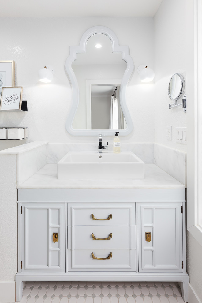 Design ideas for a traditional bathroom in Sacramento with white cabinets, grey tiles, white tiles, white walls and a vessel sink.