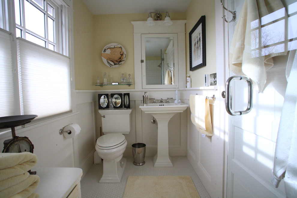 Photo of a small traditional ensuite bathroom in Portland with a pedestal sink, freestanding cabinets, a one-piece toilet, white tiles, metro tiles, yellow walls and ceramic flooring.