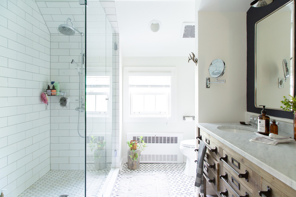 Photo of a rural bathroom in Chicago with medium wood cabinets, a built-in shower, white tiles, white walls, a submerged sink, multi-coloured floors, an open shower, white worktops and flat-panel cabinets.