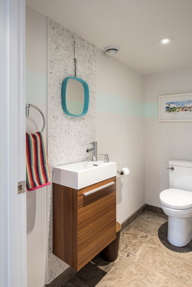 Small trendy 3/4 white tile and ceramic tile limestone floor bathroom photo in Toronto with flat-panel cabinets, medium tone wood cabinets, a two-piece toilet, white walls, solid surface countertops and a console sink