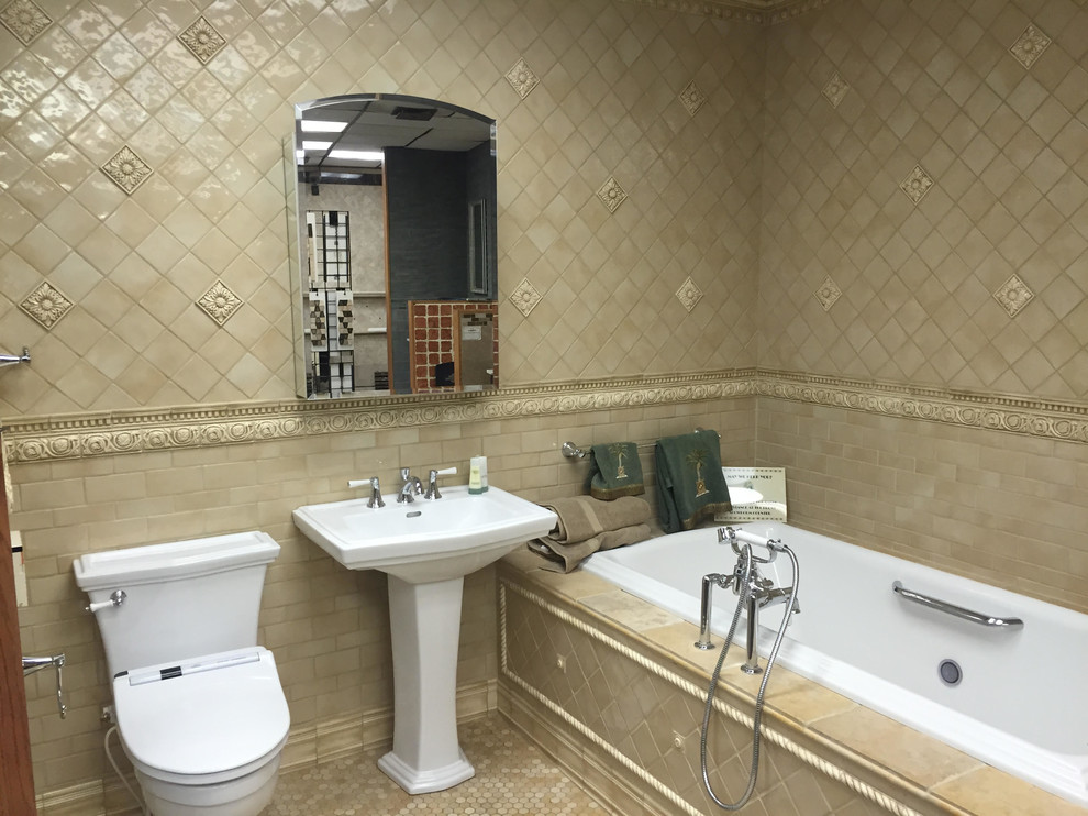 This is an example of a medium sized traditional ensuite bathroom in New York with a pedestal sink, a built-in bath, a one-piece toilet, beige tiles, ceramic tiles, beige walls, a shower/bath combination, mosaic tile flooring, beige floors and a shower curtain.