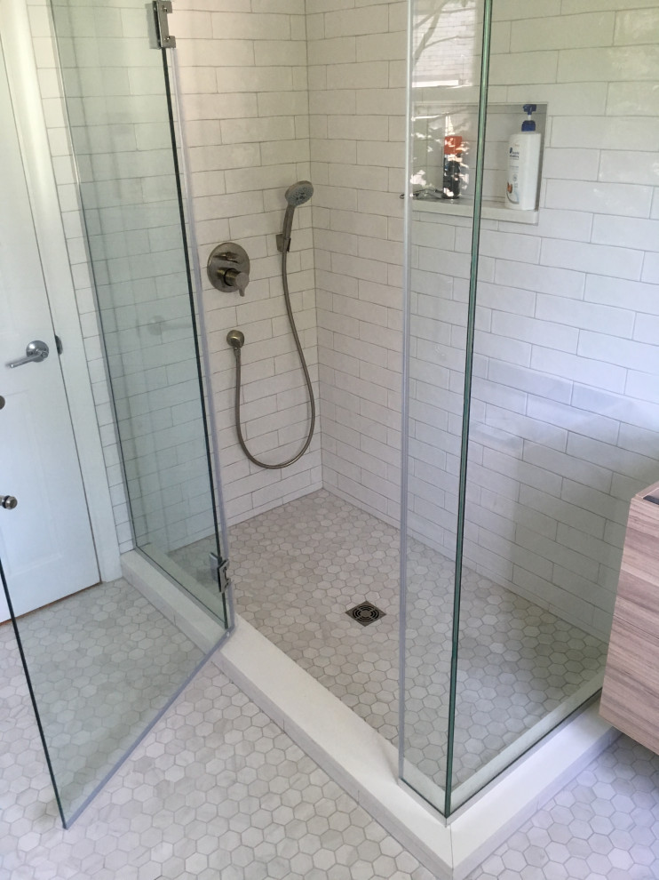 Medium sized modern shower room bathroom in Boston with flat-panel cabinets, medium wood cabinets, a walk-in shower, grey walls, marble flooring, an integrated sink, engineered stone worktops, grey floors, a hinged door and white worktops.