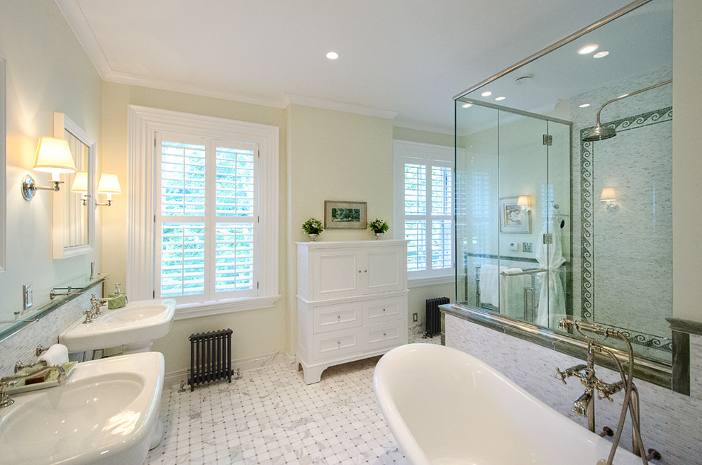 This is an example of a contemporary ensuite bathroom in Burlington with a pedestal sink, a claw-foot bath, a built-in shower, white tiles, white walls and porcelain flooring.
