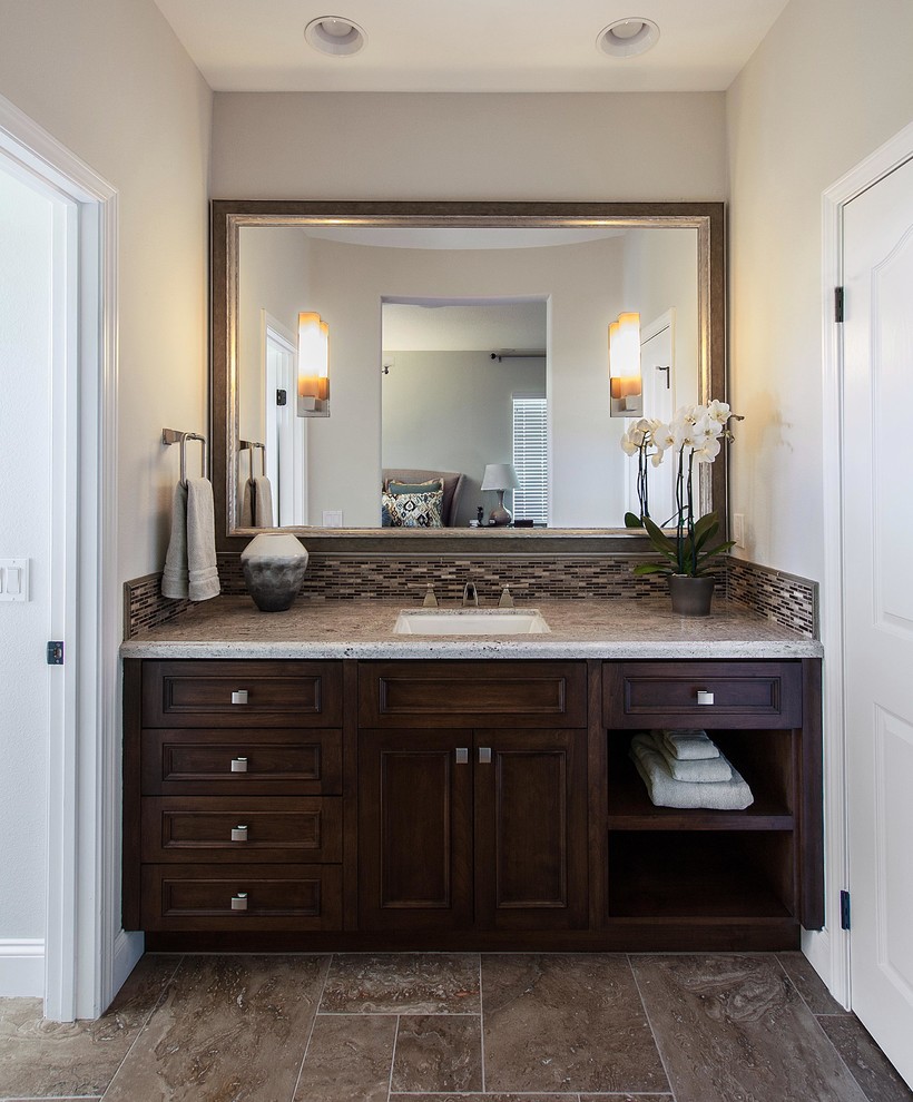 Design ideas for a medium sized traditional ensuite bathroom in Denver with a submerged sink, raised-panel cabinets, dark wood cabinets, granite worktops, a built-in bath, a shower/bath combination, a two-piece toilet, brown tiles, mosaic tiles, green walls and limestone flooring.