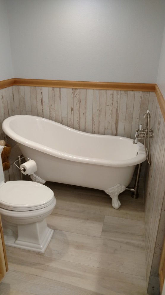 This is an example of a small rustic shower room bathroom in Tampa with a claw-foot bath, a one-piece toilet, grey walls and porcelain flooring.