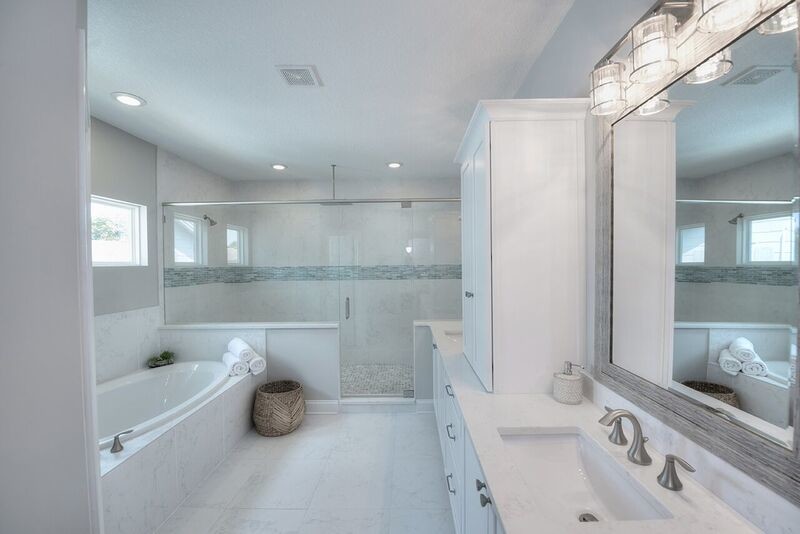 Bathroom - mid-sized coastal master gray tile marble floor and gray floor bathroom idea in Jacksonville with white cabinets, gray walls, an undermount sink, marble countertops, a hinged shower door and white countertops