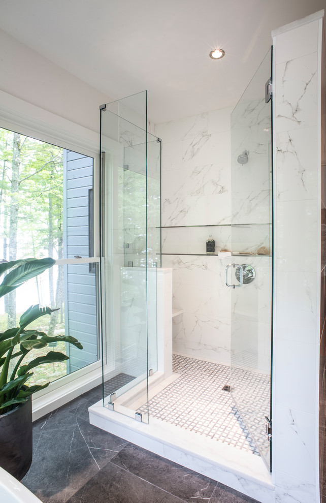 Mid-sized minimalist master black and white tile and stone tile ceramic tile and black floor bathroom photo in Portland Maine with white cabinets, a wall-mount toilet, white walls, an undermount sink, marble countertops and a hinged shower door