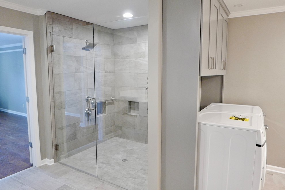 This is an example of a large traditional ensuite bathroom in Other with shaker cabinets, grey cabinets, a built-in shower, a two-piece toilet, grey tiles, porcelain tiles, grey walls, porcelain flooring, a submerged sink, engineered stone worktops, grey floors, a hinged door and white worktops.