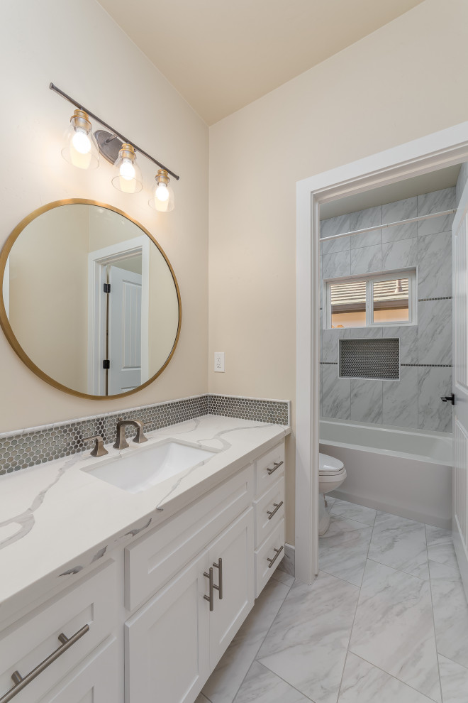 Walk-in shower - mid-sized traditional master ceramic tile and double-sink walk-in shower idea in Sacramento with shaker cabinets, white cabinets, an undermount sink, quartzite countertops, a hinged shower door, white countertops and a built-in vanity