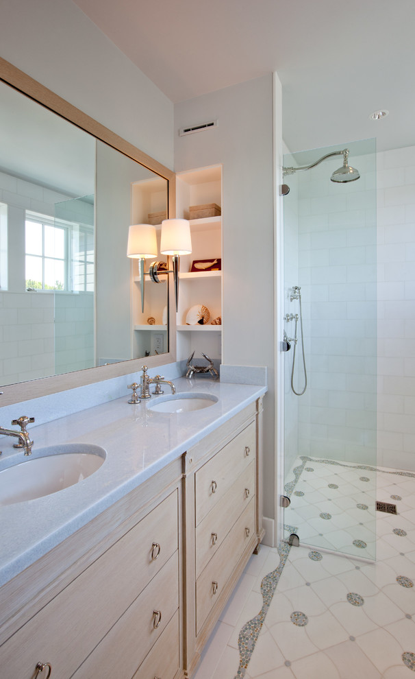 Doorless shower - small coastal white tile and stone tile doorless shower idea in Boston with furniture-like cabinets, light wood cabinets and an undermount sink