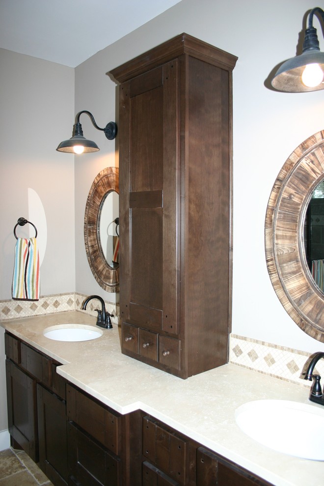 Photo of a medium sized country bathroom in Austin with shaker cabinets, dark wood cabinets, an alcove shower, travertine flooring, a submerged sink, brown floors and beige worktops.