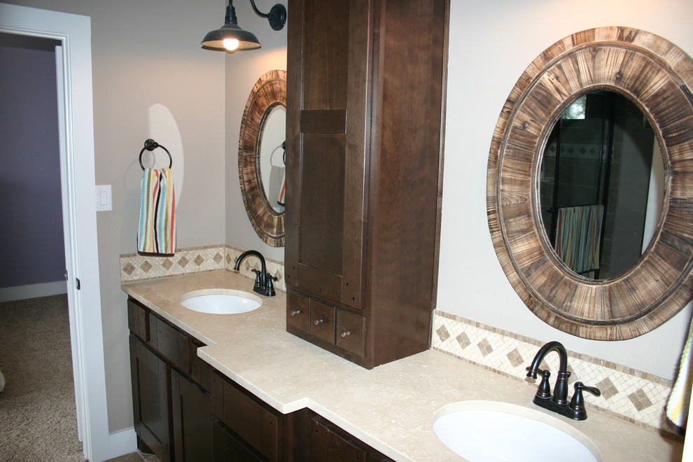 Example of a mid-sized cottage travertine floor and brown floor alcove shower design in Austin with shaker cabinets, dark wood cabinets, an undermount sink and beige countertops