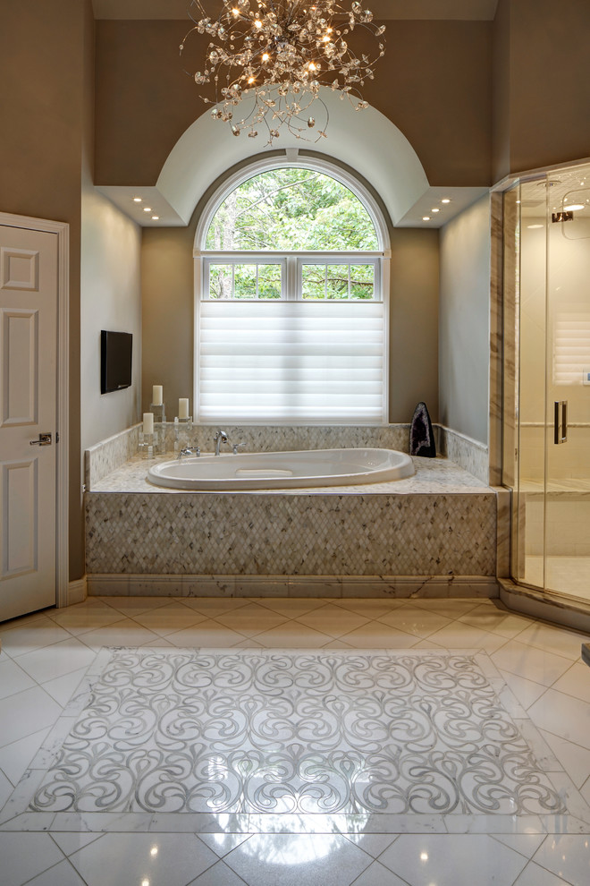 Photo of a large classic ensuite bathroom in Chicago with recessed-panel cabinets, grey cabinets, a built-in bath, an alcove shower, beige walls, ceramic flooring, marble worktops, white floors and a hinged door.