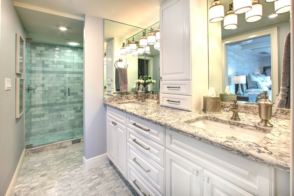 This is an example of a large traditional shower room bathroom in Miami with raised-panel cabinets, white cabinets, an alcove shower, grey tiles, marble tiles, grey walls, marble flooring, granite worktops, grey floors, a hinged door, brown worktops, double sinks and a built in vanity unit.