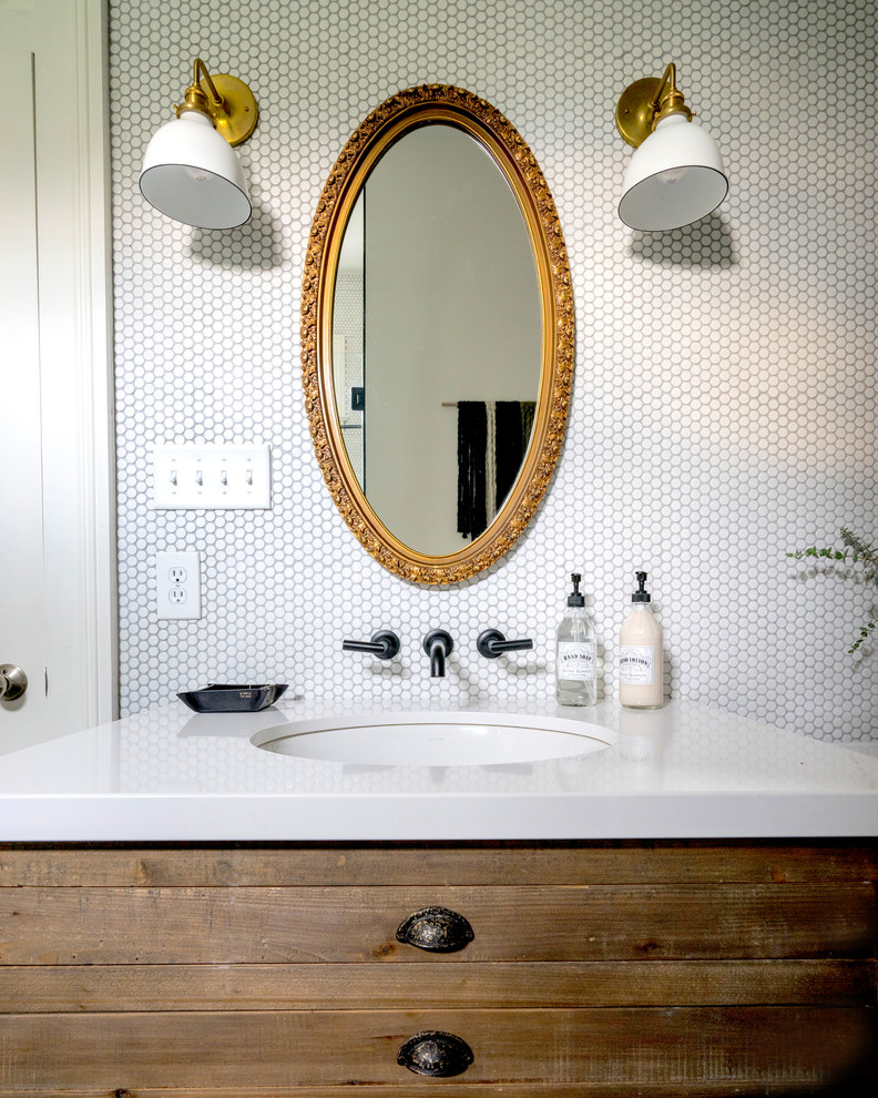 Example of a trendy white tile and ceramic tile slate floor and black floor bathroom design in New Orleans with medium tone wood cabinets, a two-piece toilet, white walls, an undermount sink, quartz countertops and a hinged shower door