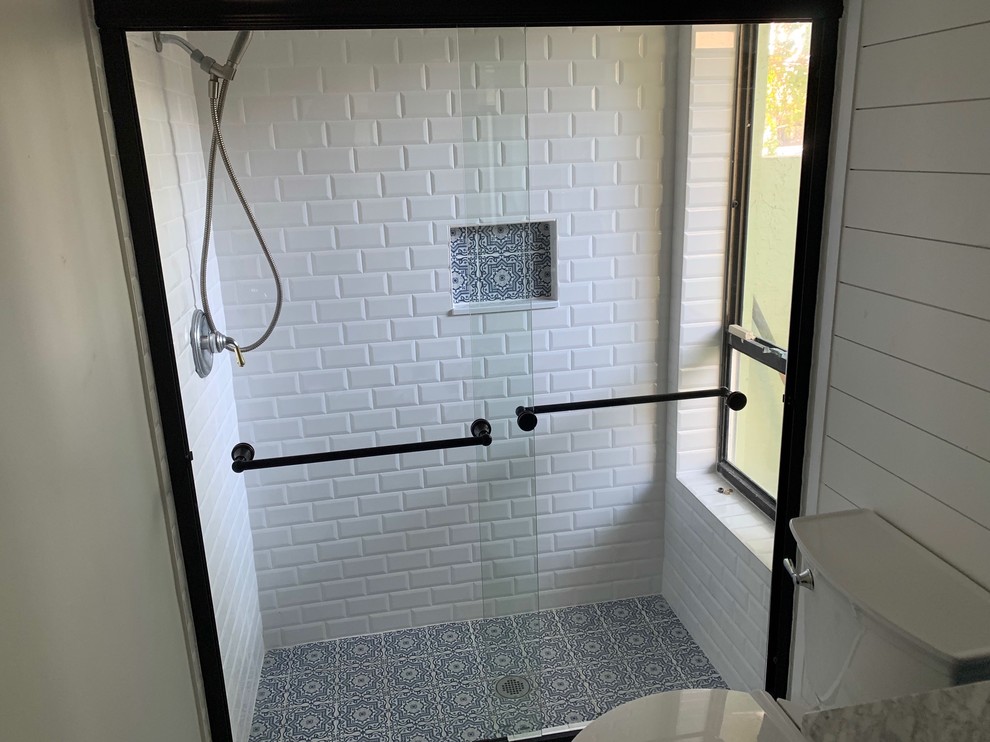 Bathroom - small shabby-chic style kids' white tile and subway tile porcelain tile and white floor bathroom idea in Other with shaker cabinets, blue cabinets, a one-piece toilet, white walls, an undermount sink, quartz countertops and gray countertops
