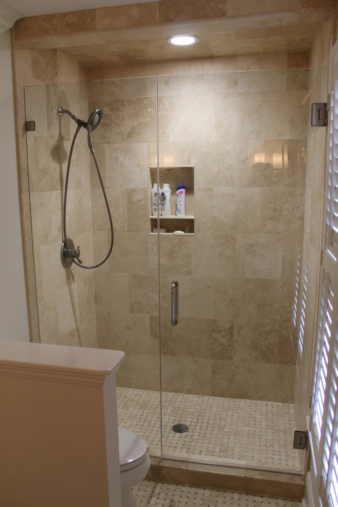 Medium sized traditional shower room bathroom in Miami with a submerged sink, freestanding cabinets, white cabinets, granite worktops, an alcove shower, a two-piece toilet, beige tiles, stone tiles, white walls and mosaic tile flooring.