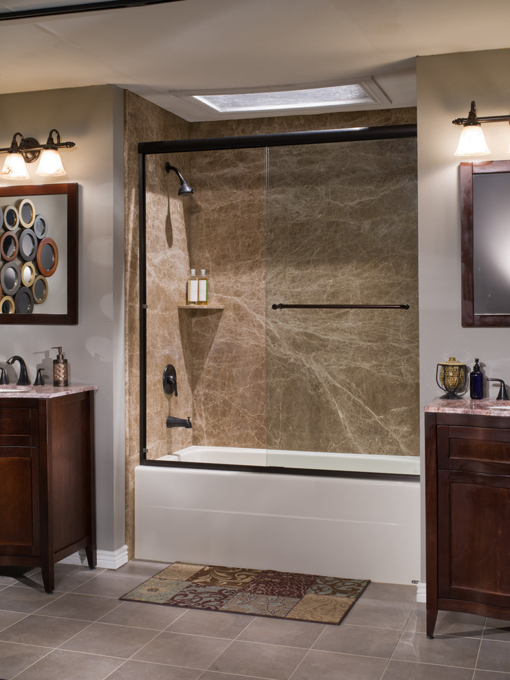 Example of a mid-sized minimalist master brown tile and stone slab bathroom design in Detroit with a drop-in sink, furniture-like cabinets, dark wood cabinets, marble countertops and beige walls