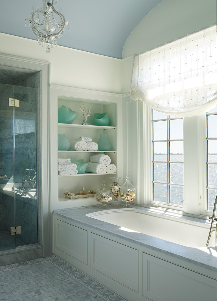 Beach style alcove shower photo in New York with an undermount tub