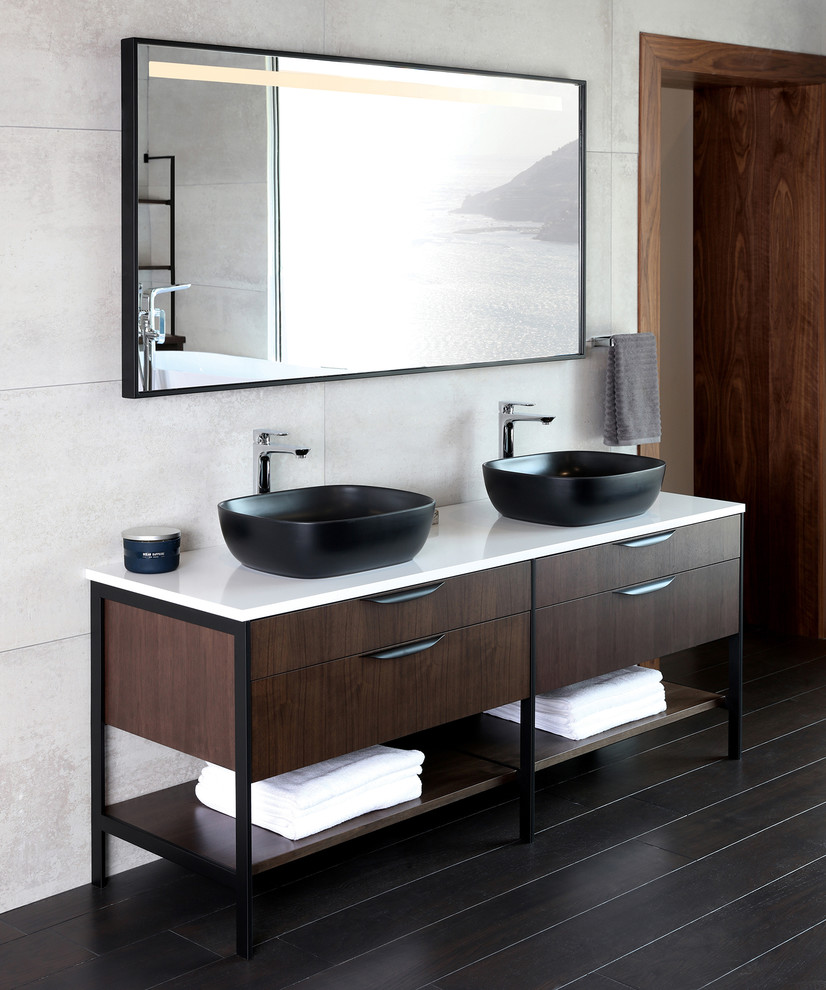 Design ideas for an expansive contemporary ensuite bathroom in Chicago with freestanding cabinets, dark wood cabinets, a freestanding bath, a vessel sink, solid surface worktops and white worktops.