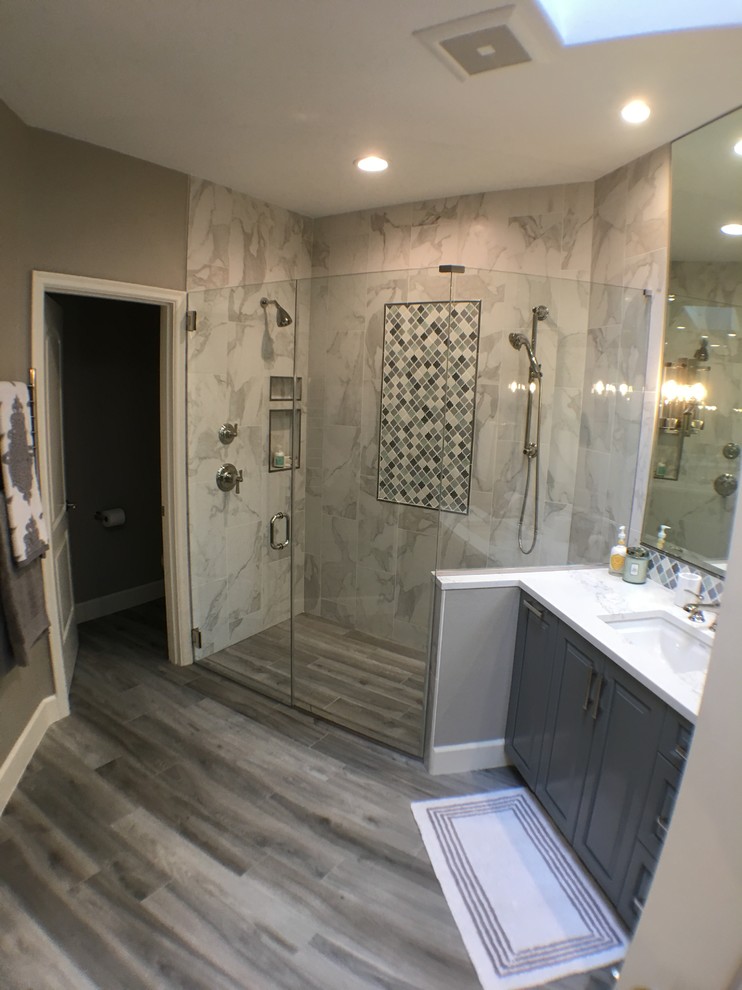 Inspiration for a mid-sized transitional master white tile and porcelain tile porcelain tile and gray floor walk-in shower remodel in Portland with beaded inset cabinets, gray cabinets, a one-piece toilet, beige walls, an undermount sink, quartz countertops and a hinged shower door