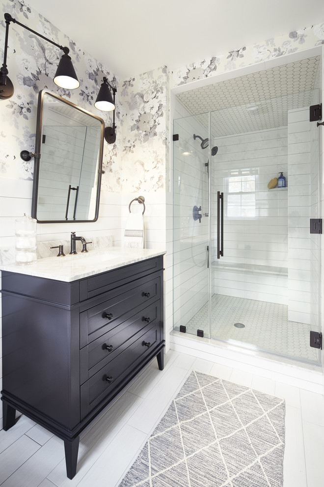 Inspiration for a medium sized contemporary ensuite bathroom in New York with freestanding cabinets, dark wood cabinets, a double shower, a one-piece toilet, white tiles, ceramic tiles, white walls, porcelain flooring, an integrated sink, marble worktops, white floors and a hinged door.
