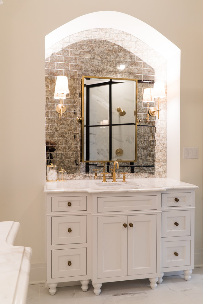 Corner shower - mid-sized transitional master white tile and porcelain tile corner shower idea in Louisville with flat-panel cabinets, white cabinets, a two-piece toilet, white walls, an undermount sink and marble countertops