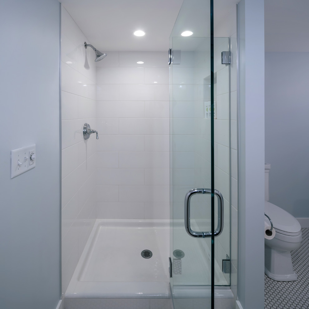 Inspiration for a medium sized traditional shower room bathroom in Portland with an alcove shower, white tiles, metro tiles, blue walls, porcelain flooring, a pedestal sink, white floors and a hinged door.