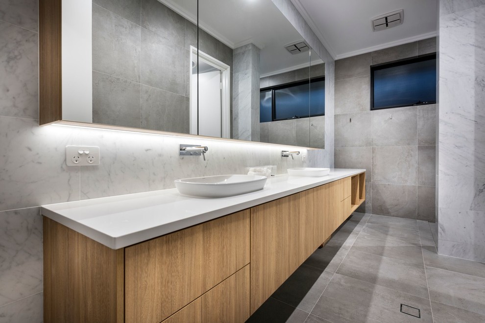 This is an example of a large contemporary bathroom in Perth with light wood cabinets and grey tiles.