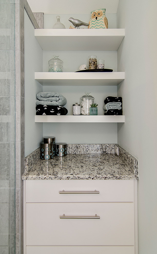 Example of a small transitional master gray tile and ceramic tile ceramic tile bathroom design in Dallas with an undermount sink, shaker cabinets, medium tone wood cabinets, granite countertops, a two-piece toilet and gray walls