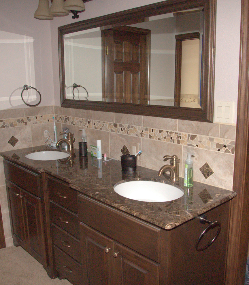 Exemple d'une douche en alcôve chic en bois brun avec un lavabo encastré, un placard avec porte à panneau surélevé, un plan de toilette en granite, une baignoire encastrée, WC à poser, un carrelage beige et des carreaux de porcelaine.