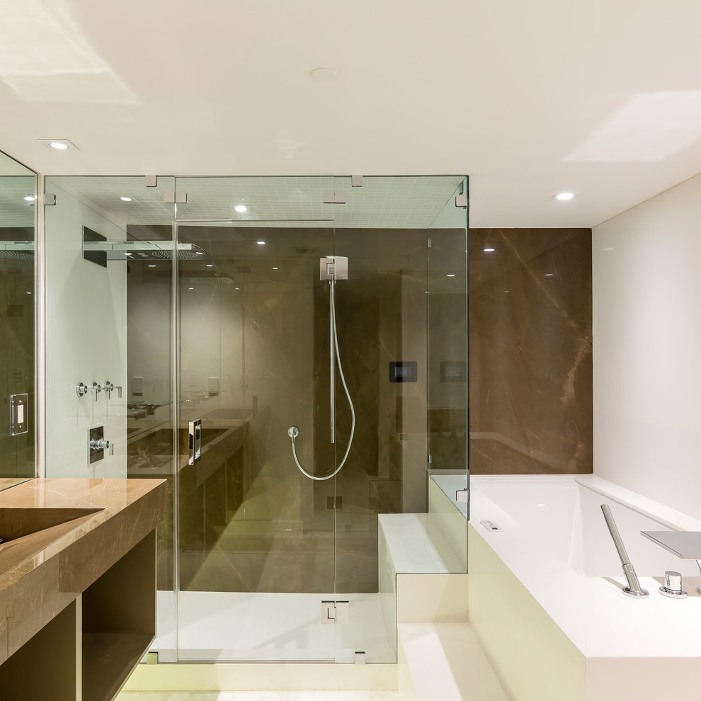 This is an example of a contemporary bathroom in Essex with open cabinets, brown cabinets, a submerged bath, white walls, an integrated sink, marble worktops, white floors and a hinged door.