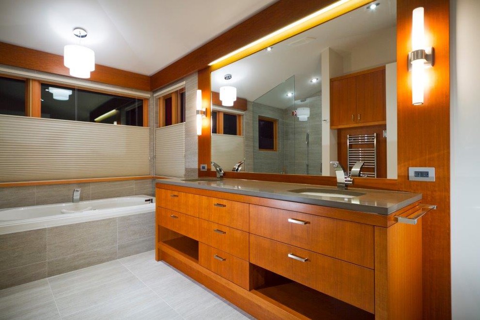 Design ideas for a large contemporary ensuite bathroom in Vancouver with flat-panel cabinets, medium wood cabinets, a built-in bath, an alcove shower, white walls, vinyl flooring, a submerged sink and quartz worktops.