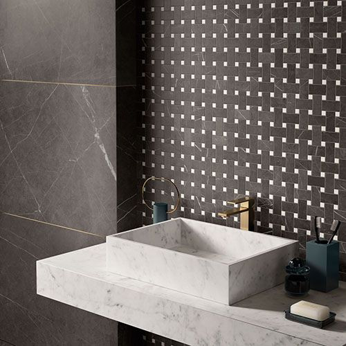 Example of a trendy porcelain tile porcelain tile bathroom design in Hampshire with a wall-mount sink and tile countertops